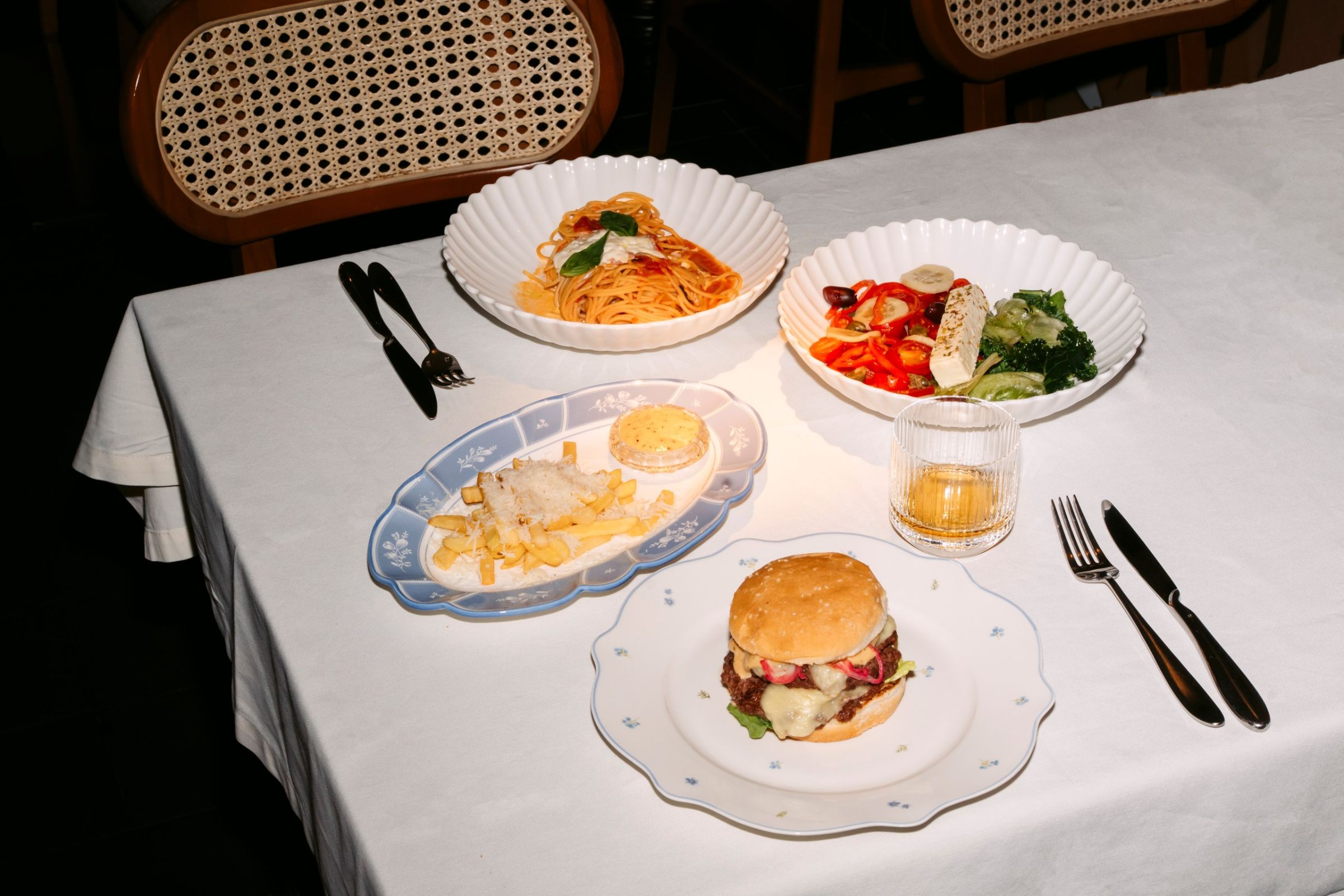 rrf-2026-anna-bistrot Сет «Anna bistrot»: спагетти маринара, греческий салат, фри с соусом и смэш-бургер на белом столе